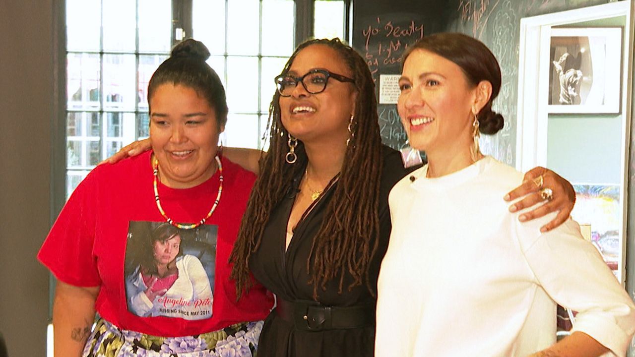 http://Ava%20DuVernay%20puts%20her%20arms%20around%20the%20shoulders%20of%20two%20women%20filmmakers%20as%20they%20smile%20for%20the%20cameras.