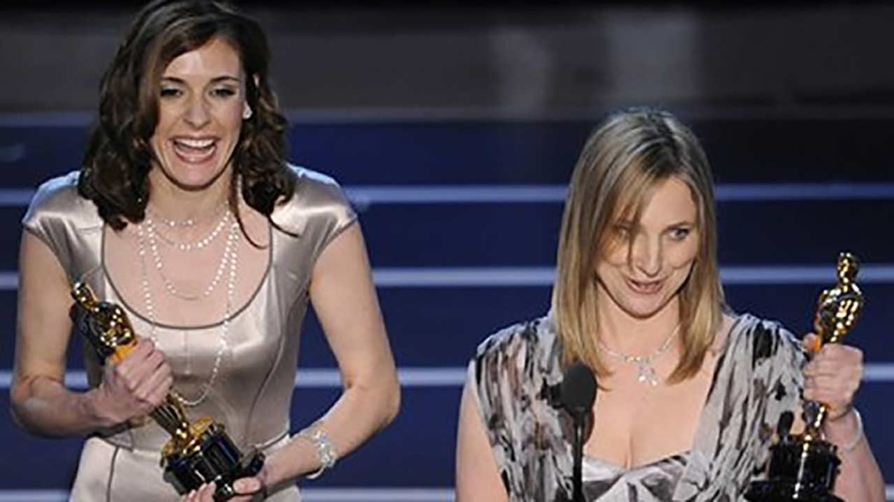 Two women holding oscars